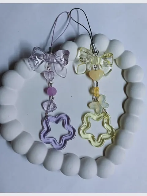 Two handmade beaded phone charms with star pendants